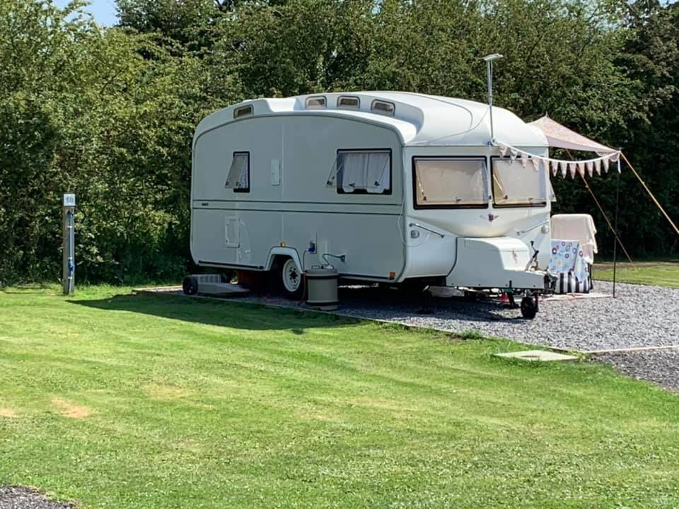 Classic caravan pitched with awning and bunting