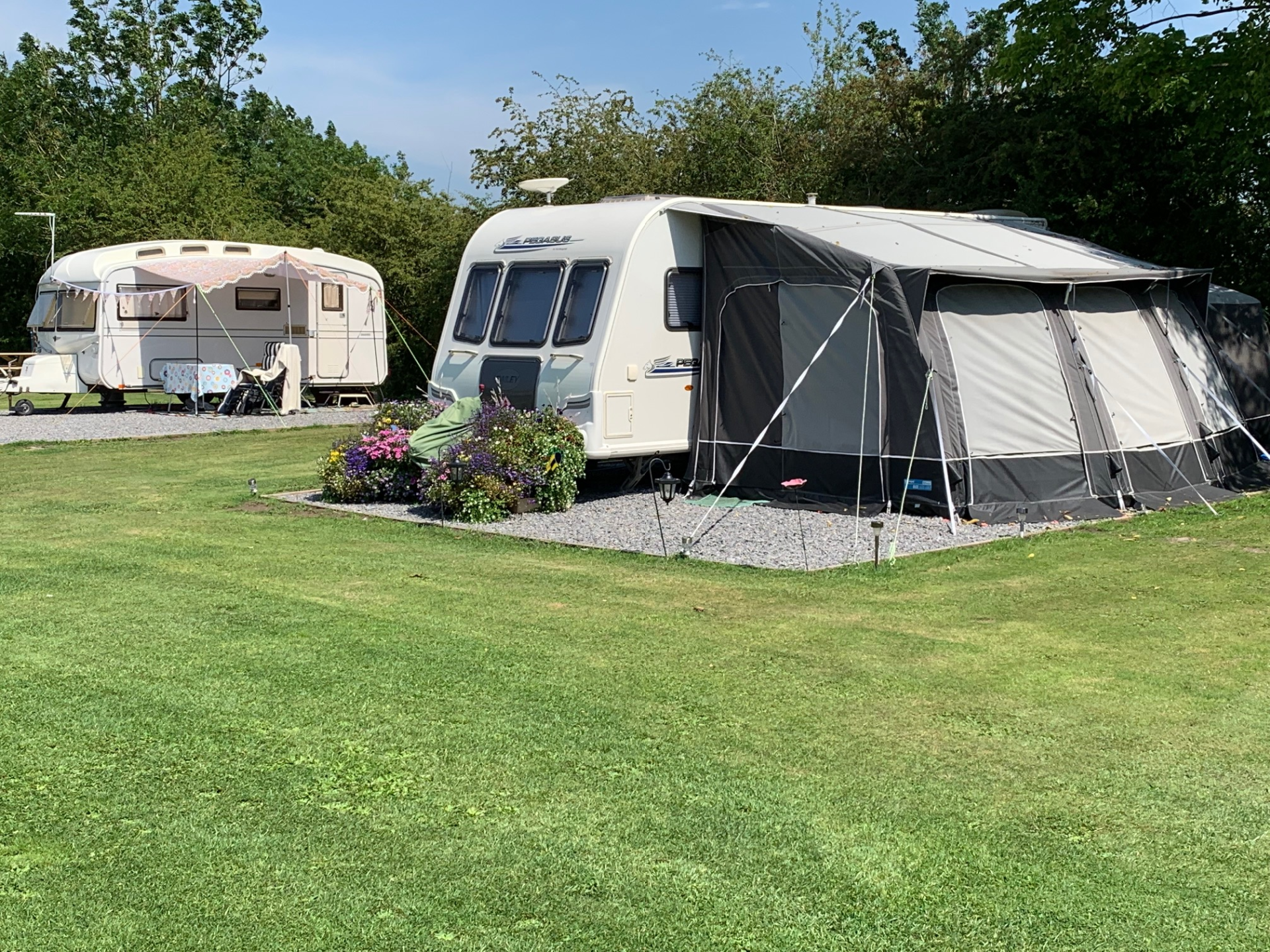 Caravan pitched with grey awning attached